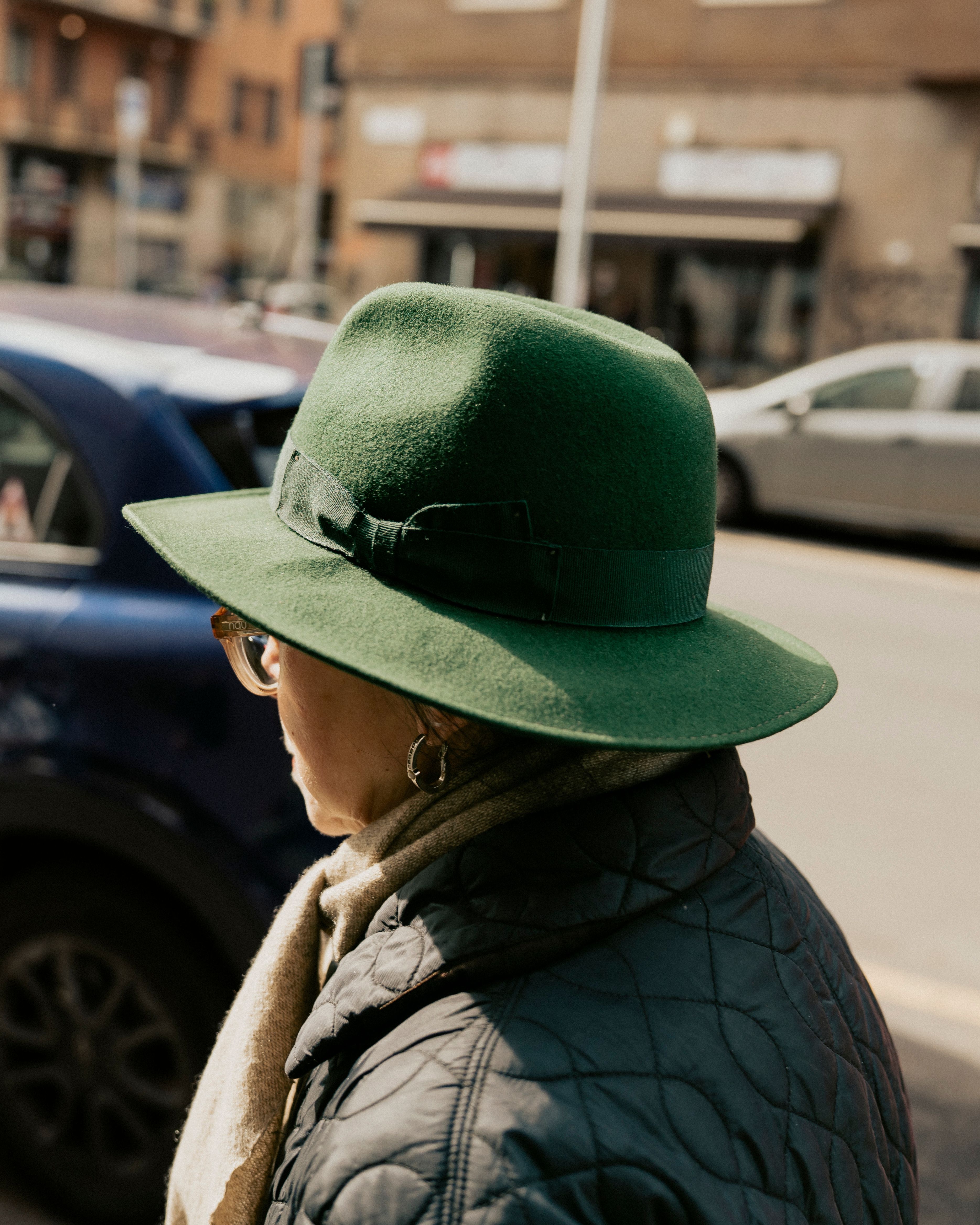 Old lady with a beautiful green hat in the streets of Milano